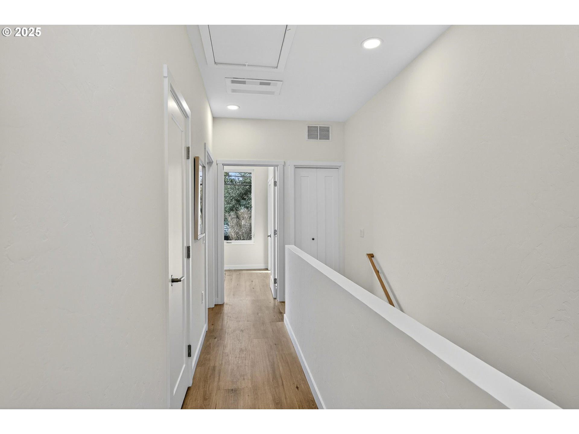7208 Northeast Going Street Portland, OR 97218 - Photo 21 of 35 a hallway with wooden floor windows and stairs