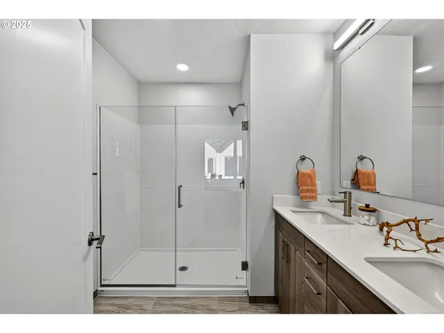 a bathroom with a shower sink and mirror