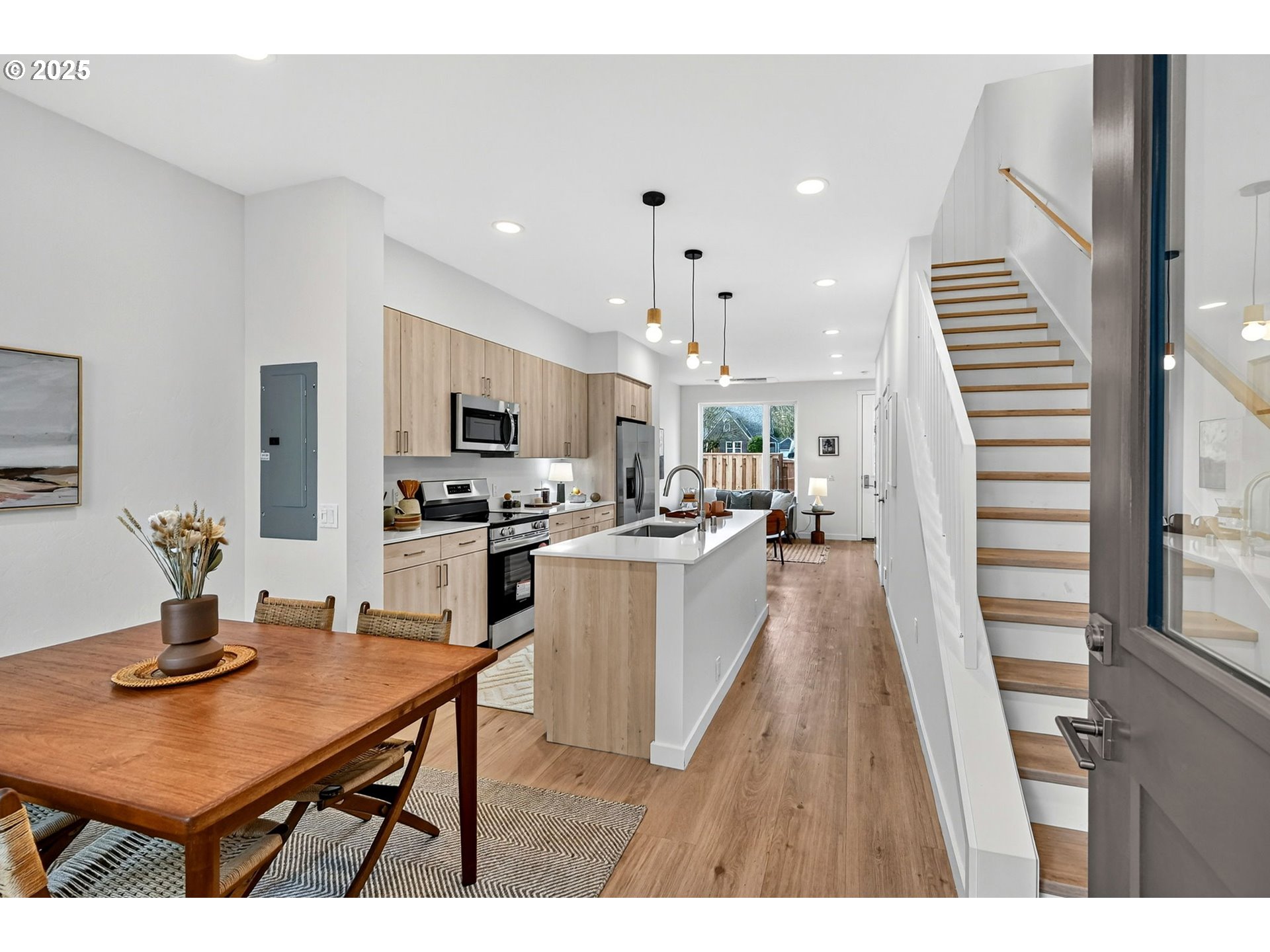 7208 Northeast Going Street Portland, OR 97218 - Photo 7 of 35 a open kitchen with a table chairs refrigerator and microwave