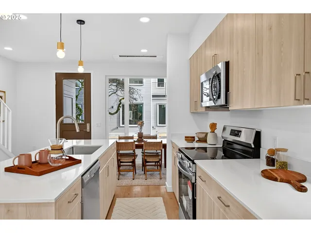 a kitchen with a sink stove and cabinets
