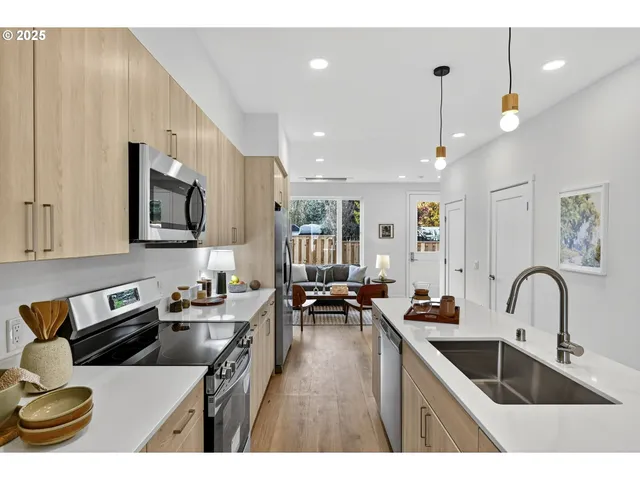 a kitchen with a sink a stove and cabinets