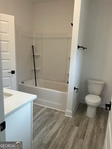 a bathroom with a sink a toilet and a bathtub
