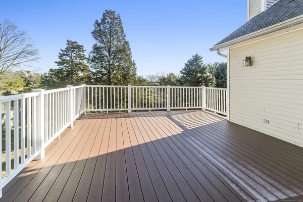 a view of balcony with wooden floor and fence