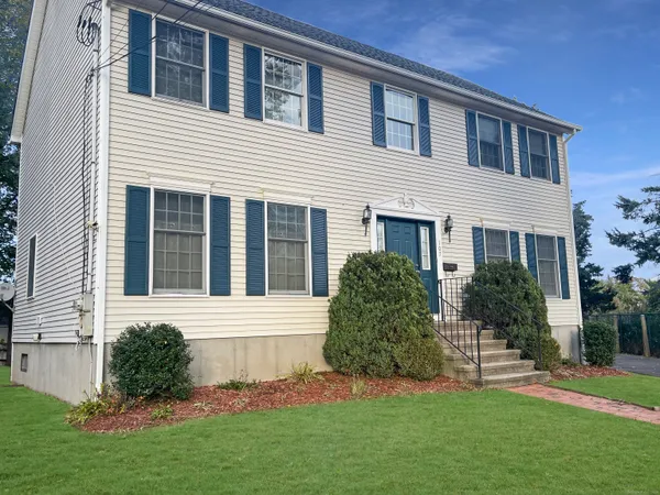 a front view of house with yard and green space