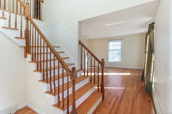 a view of entryway with wooden floor and stairs