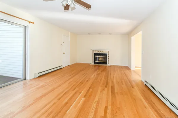 a view of empty room with wooden floor