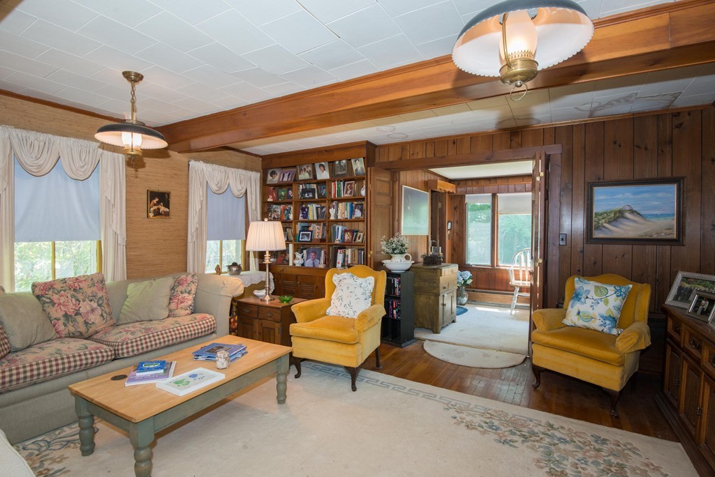 1 R Ticehurst Lane Marblehead, MA 01945 - Photo 8 of 21 a living room with furniture a table and a chandelier