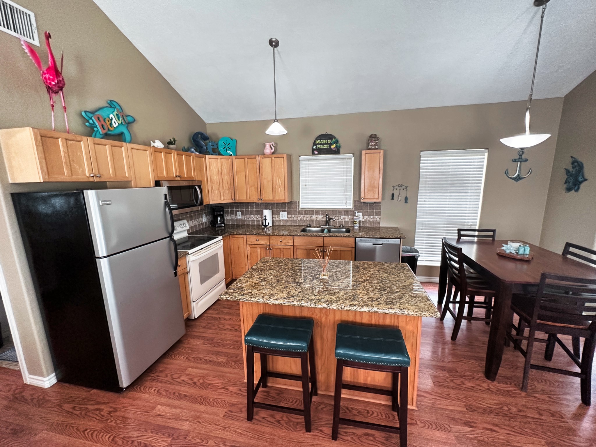 1867 County Road 291 Sargent, TX 77414 - Photo 13 of 38 a kitchen with stainless steel appliances granite countertop a table chairs and a refrigerator