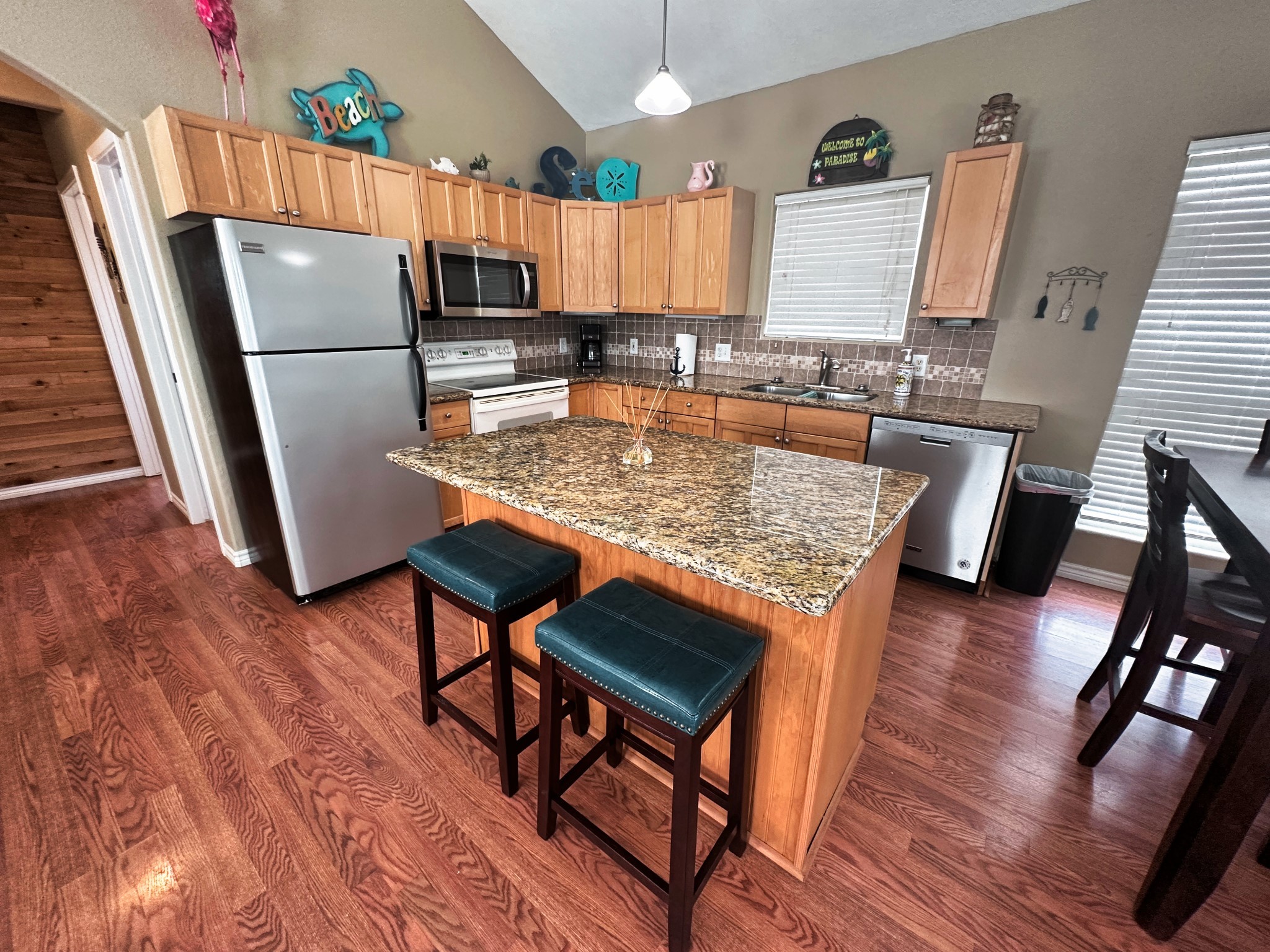1867 County Road 291 Sargent, TX 77414 - Photo 14 of 38 a kitchen with stainless steel appliances granite countertop a refrigerator microwave and stove