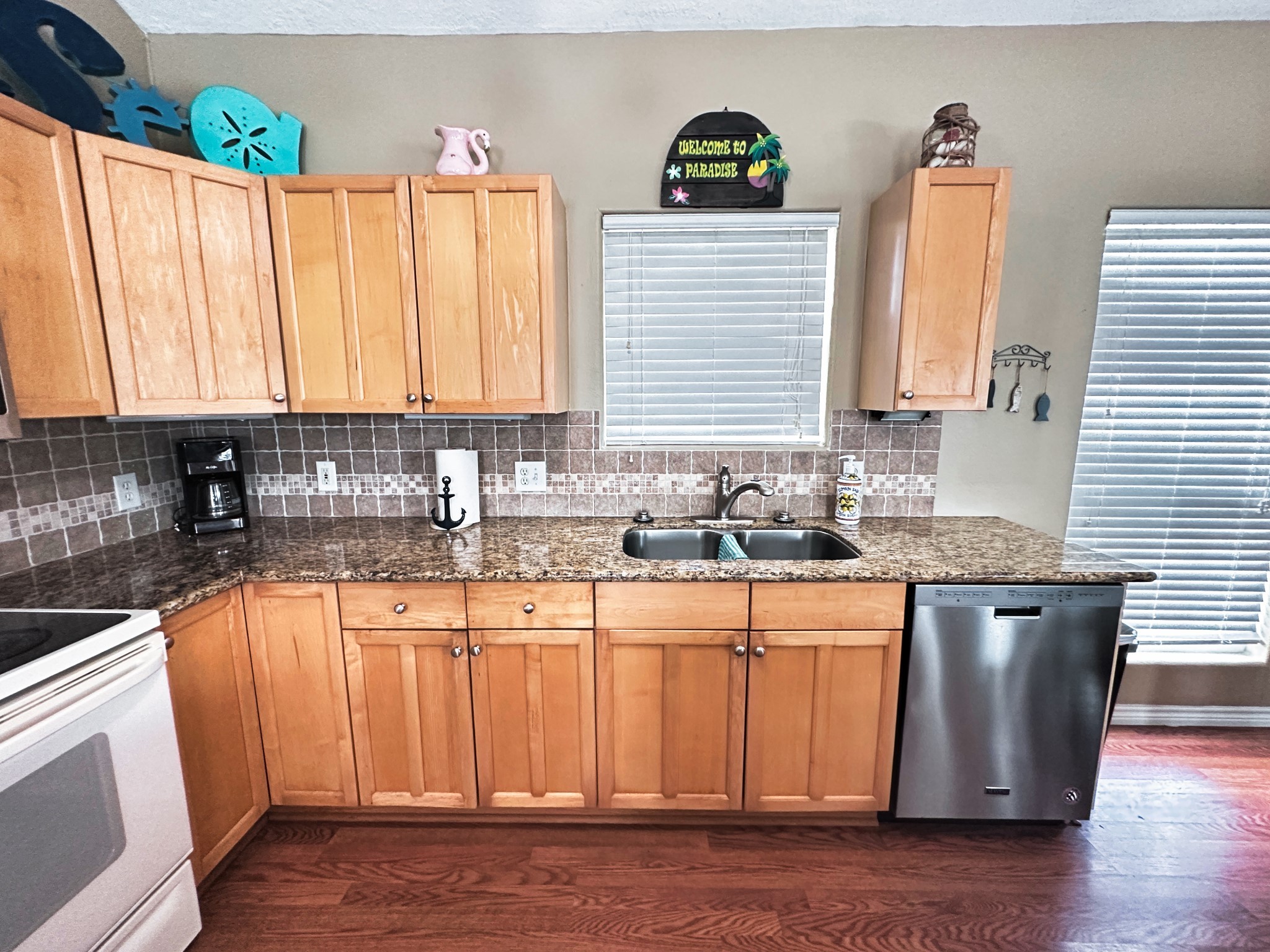 1867 County Road 291 Sargent, TX 77414 - Photo 16 of 38 a kitchen with granite countertop a sink a window stainless steel appliances and cabinets