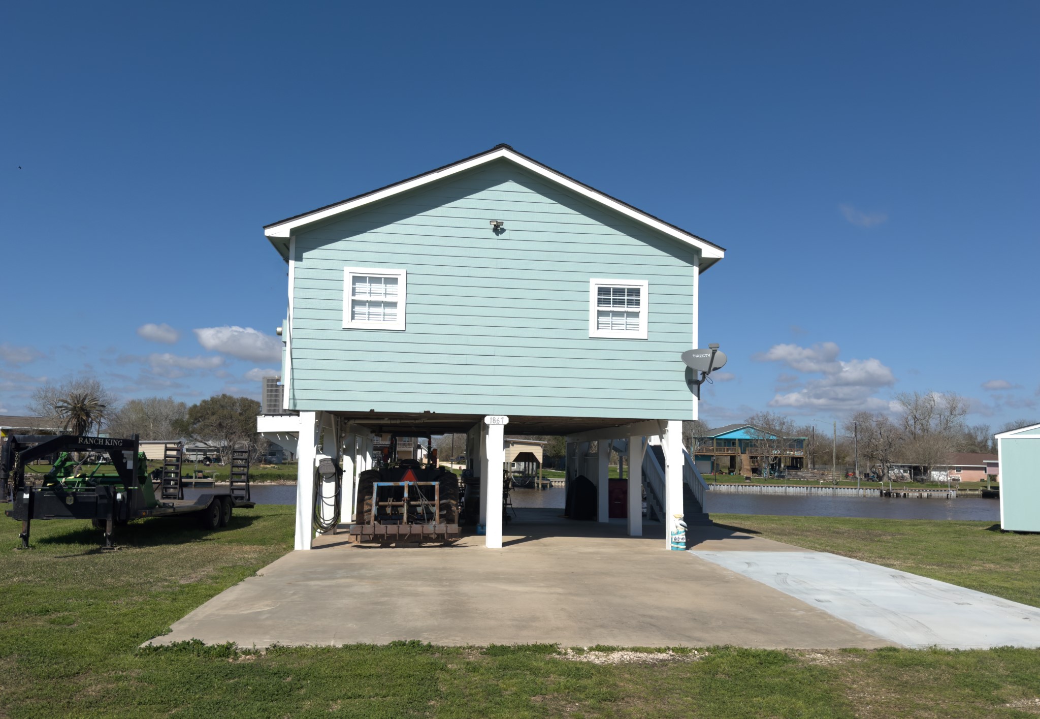 1867 County Road 291 Sargent, TX 77414 - Photo 4 of 38 a view of house with yard and car parked