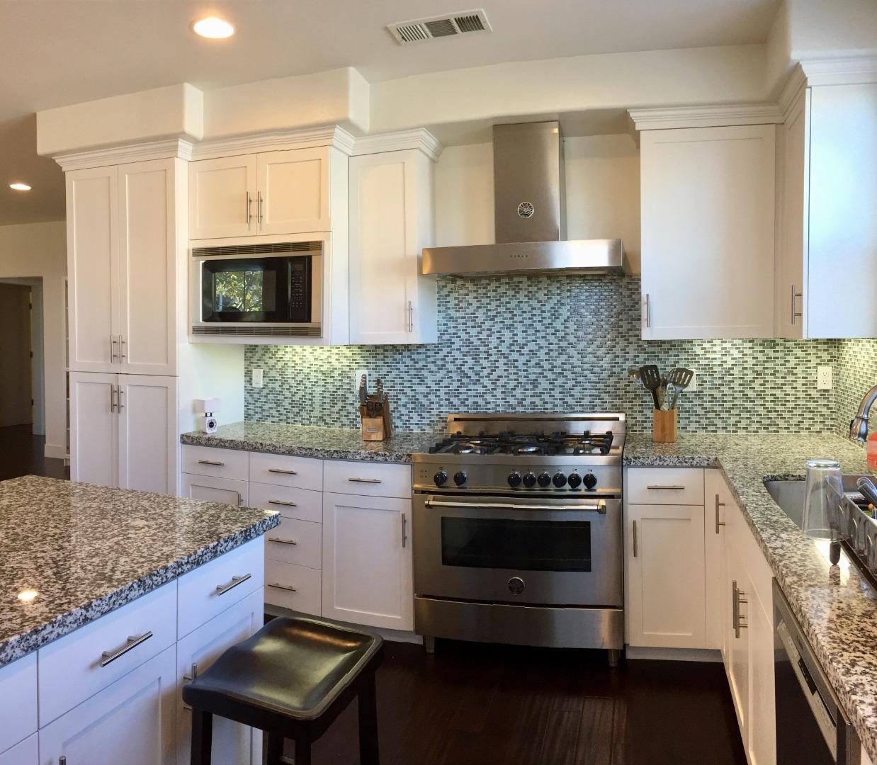 458 Landeros Drive San Mateo, CA 94403 - Photo 11 of 42 a kitchen with stainless steel appliances granite countertop a stove and a microwave