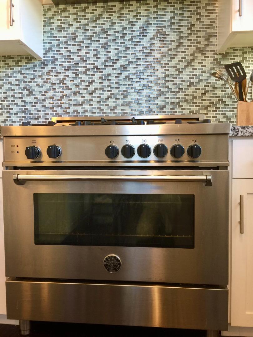 458 Landeros Drive San Mateo, CA 94403 - Photo 12 of 42 a stove top oven sitting inside of a kitchen