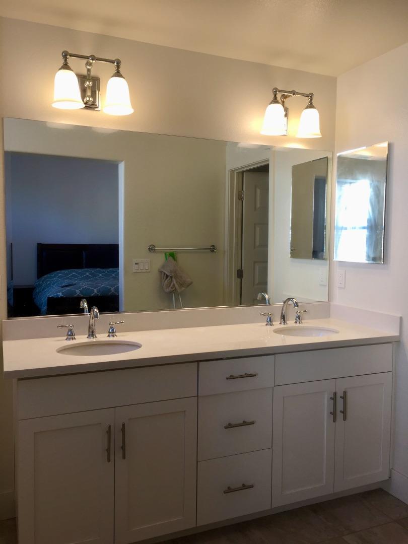 458 Landeros Drive San Mateo, CA 94403 - Photo 14 of 42 a bathroom with a double vanity sink and a mirror