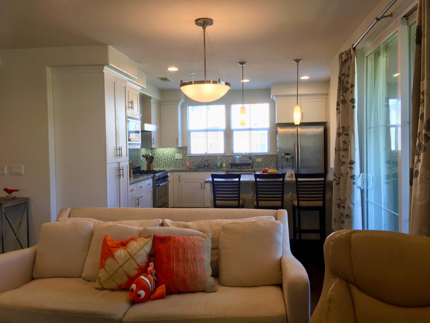 458 Landeros Drive San Mateo, CA 94403 - Photo 7 of 42 a living room with furniture kitchen view and a chandelier