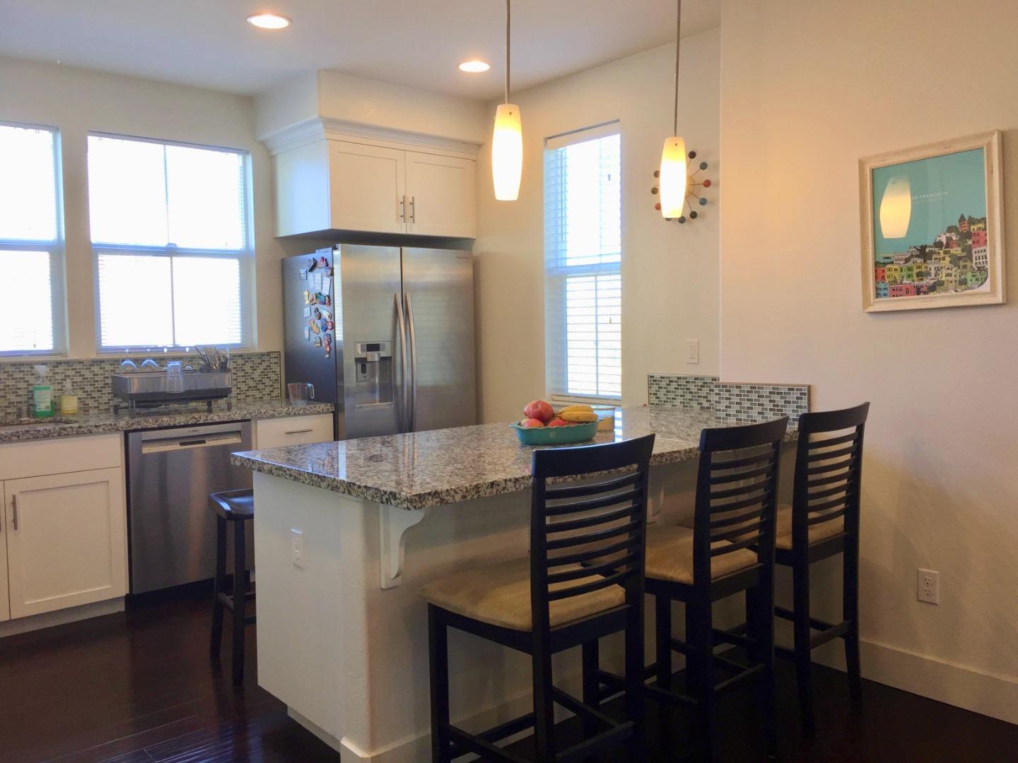 458 Landeros Drive San Mateo, CA 94403 - Photo 8 of 42 a kitchen with granite countertop a table chairs sink and window
