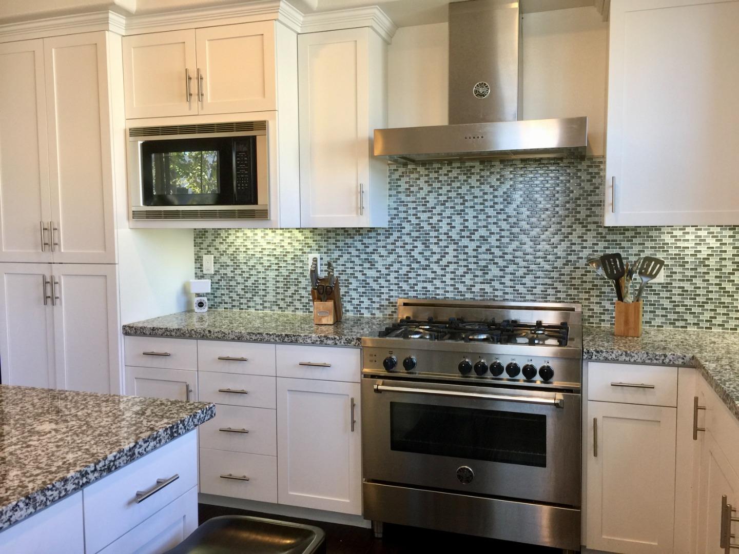 458 Landeros Drive San Mateo, CA 94403 - Photo 9 of 42 a kitchen with granite countertop white cabinets and appliances