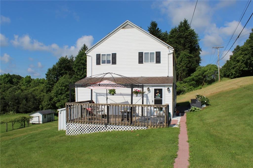 a front view of a house with a yard table and chairs