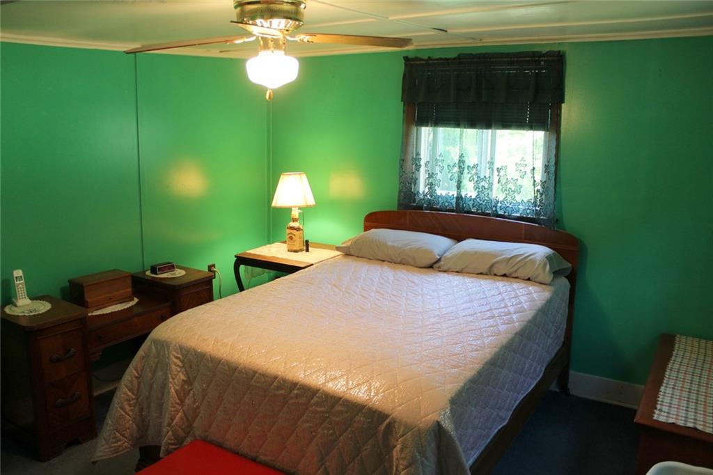 640 Cherry Road Chicora, PA 16025 - Photo 15 of 24 a bedroom with a bed and a chandelier