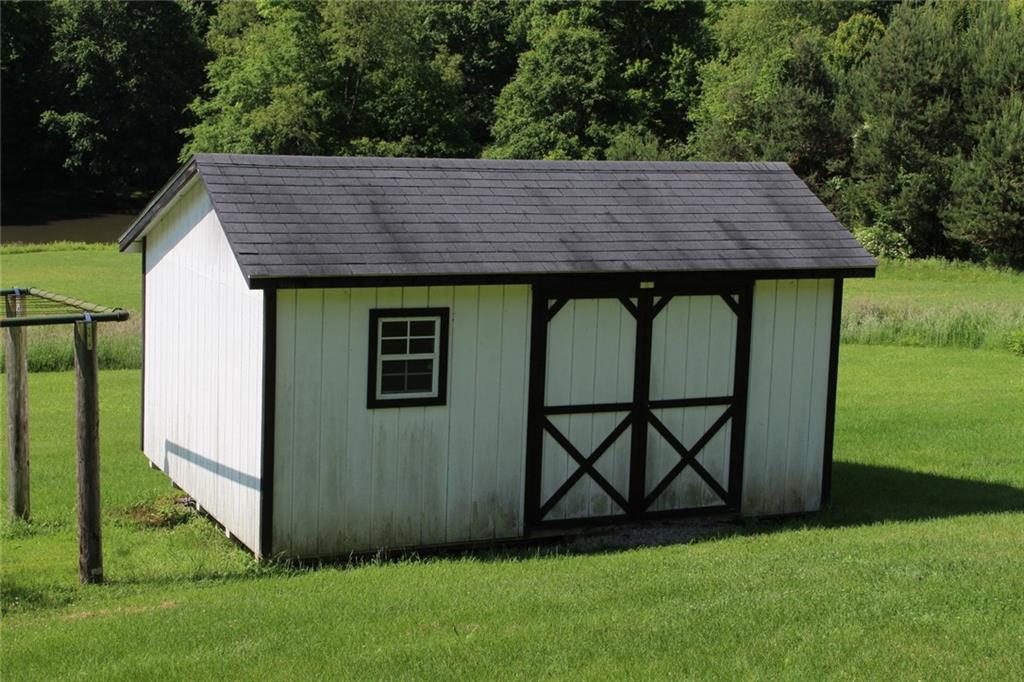 640 Cherry Road Chicora, PA 16025 - Photo 22 of 24 a view of a backyard with barn and a garden