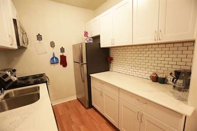 1414 Austin Street, Unit 1 Houston, TX 77002 - Photo 6 of 8 a bathroom with a sink and a washing machine