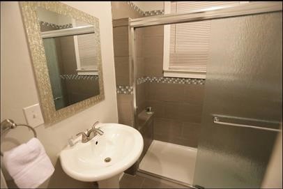 1414 Austin Street, Unit 1 Houston, TX 77002 - Photo 8 of 8 a bathroom with a sink and mirror