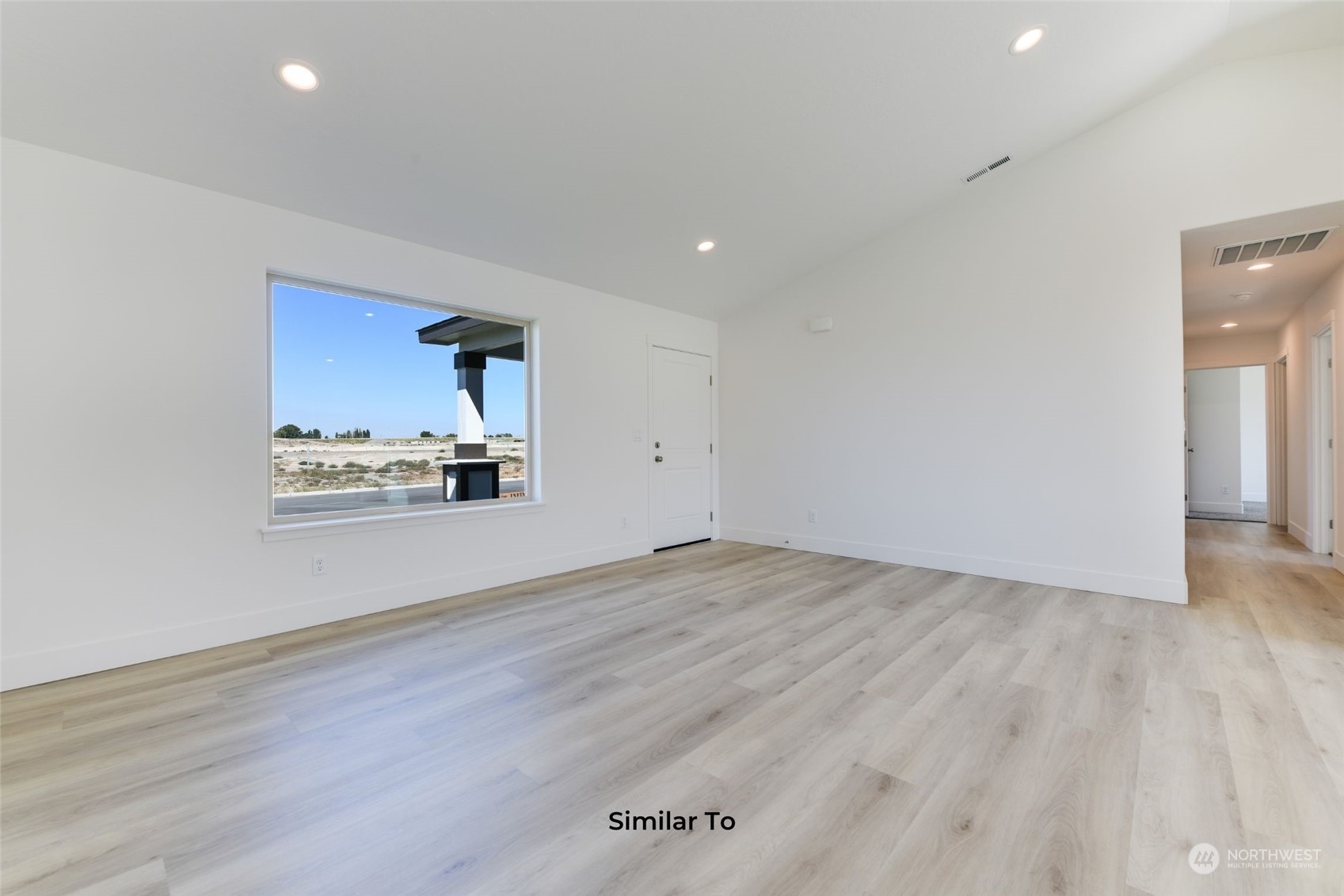 209 North Sandy Loop Moses Lake, WA 98837 - Photo 4 of 19 wooden floor in an empty room with a window
