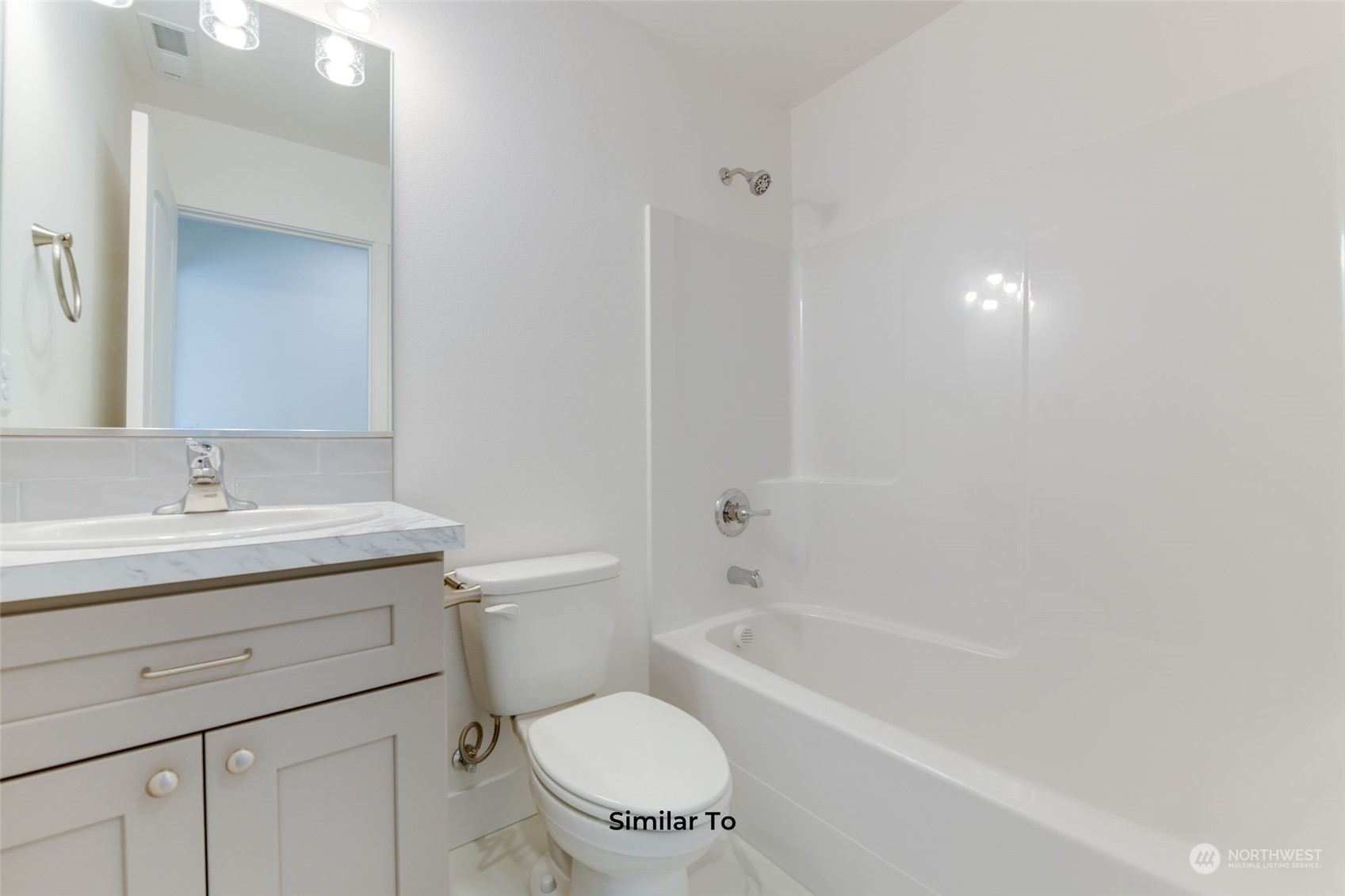 209 North Sandy Loop Moses Lake, WA 98837 - Photo 10 of 19 a bathroom with a granite countertop toilet a sink and a bathtub