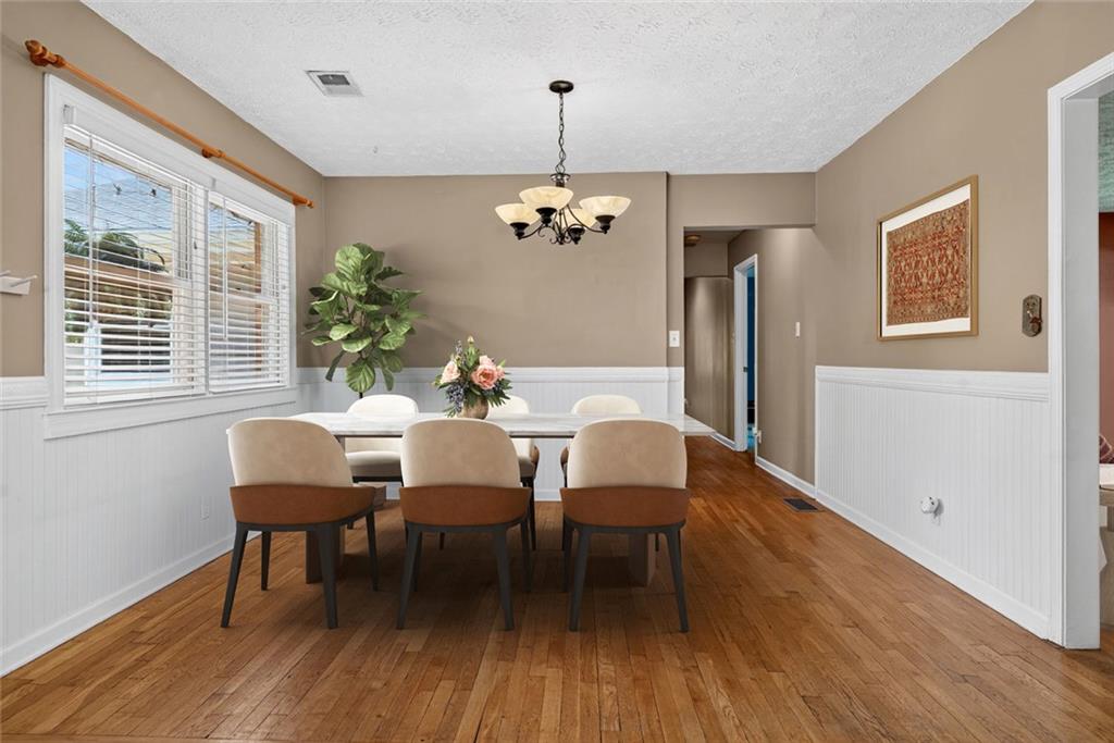 615 Tanner Road Dacula, GA 30019 - Photo 25 of 57 a dining room with furniture a chandelier and wooden floor