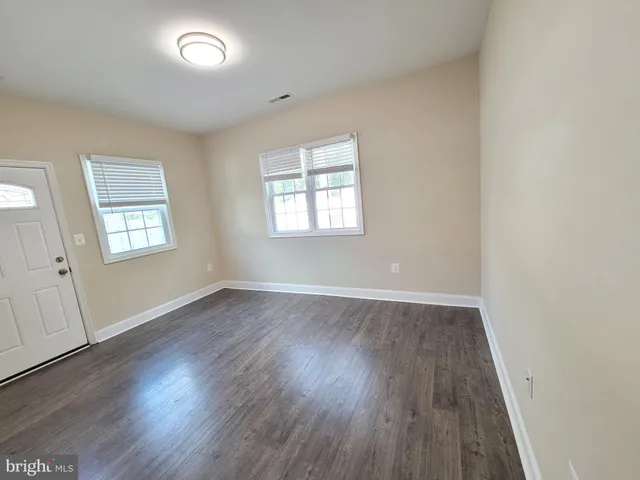 a kitchen with a center island appliances and cabinets