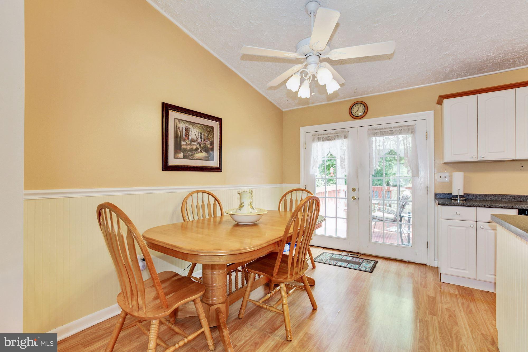 509 Sunset Knoll Road Pasadena, MD 21122 - Photo 8 of 22 a view of a dining room with furniture a chandelier and wooden floor
