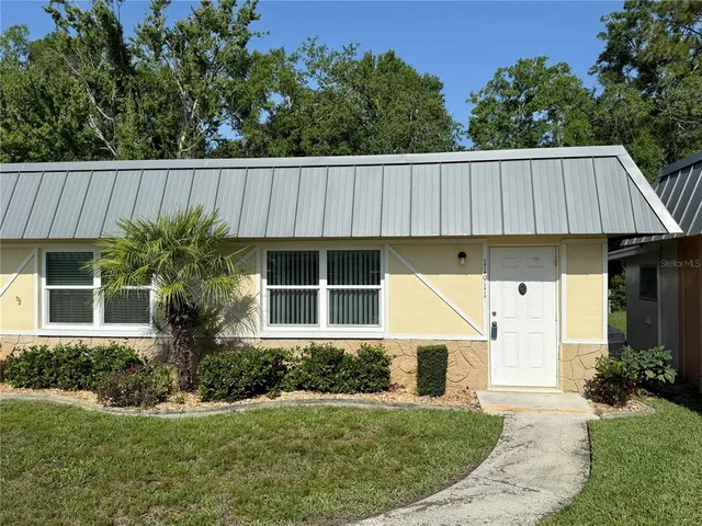 a view of a house with a yard