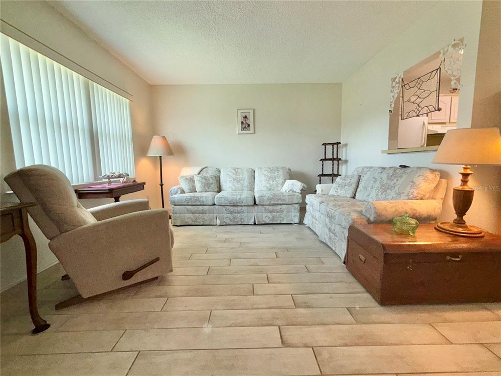 11911 Bayonet Lane New Port Richey, FL 34654 - Photo 2 of 26 a living room with furniture and a large window