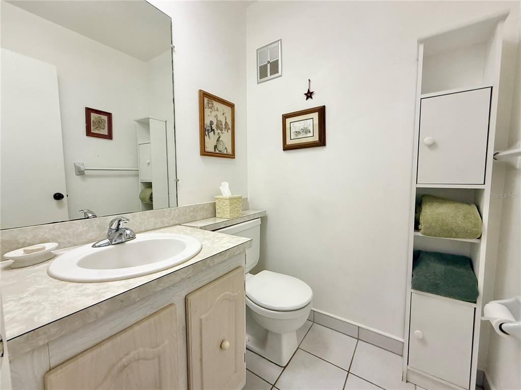 11911 Bayonet Lane New Port Richey, FL 34654 - Photo 6 of 26 a bathroom with a toilet a sink and mirror