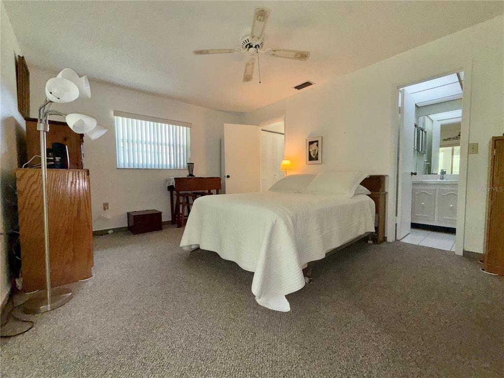 11911 Bayonet Lane New Port Richey, FL 34654 - Photo 7 of 26 a bedroom with bed and window