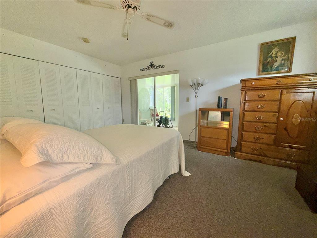 11911 Bayonet Lane New Port Richey, FL 34654 - Photo 8 of 26 a bedroom with a bed and a closet