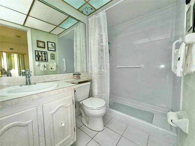 a bathroom with a double vanity sink toilet and shower