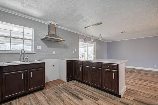 a kitchen with stainless steel appliances granite countertop a sink and wooden cabinets
