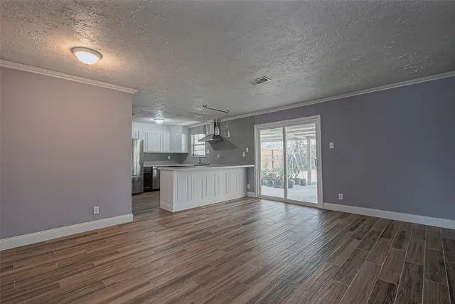 a view of kitchen and wooden floor