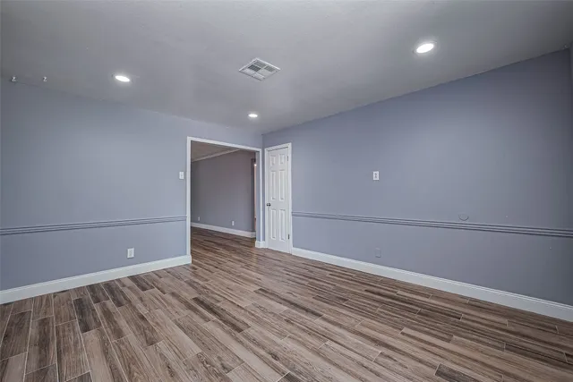a view of a room with wooden floor