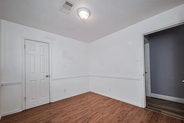 an empty room with wooden floor