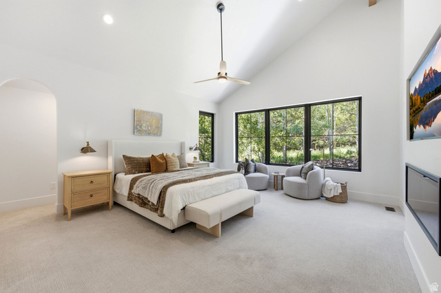 3027 Homestead Road Park City, UT 84098 - Photo 22 of 62 Spacious room featuring vaulted ceilings, a contemporary ceiling fan, and expansive windows with dark frames