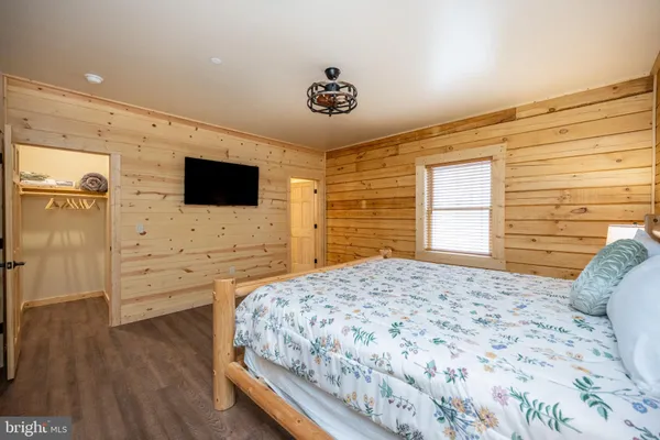 a room with wooden floor and book shelf
