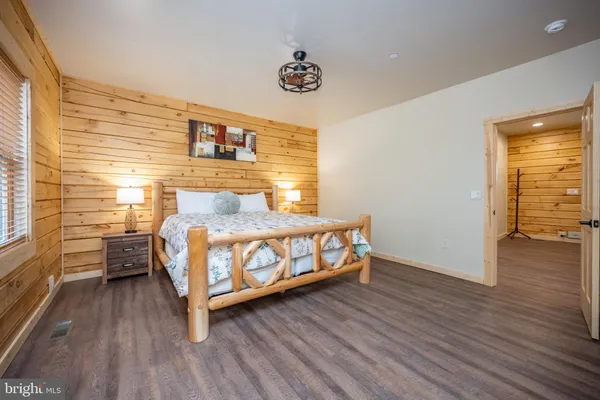 a bedroom with furniture and a flat screen tv