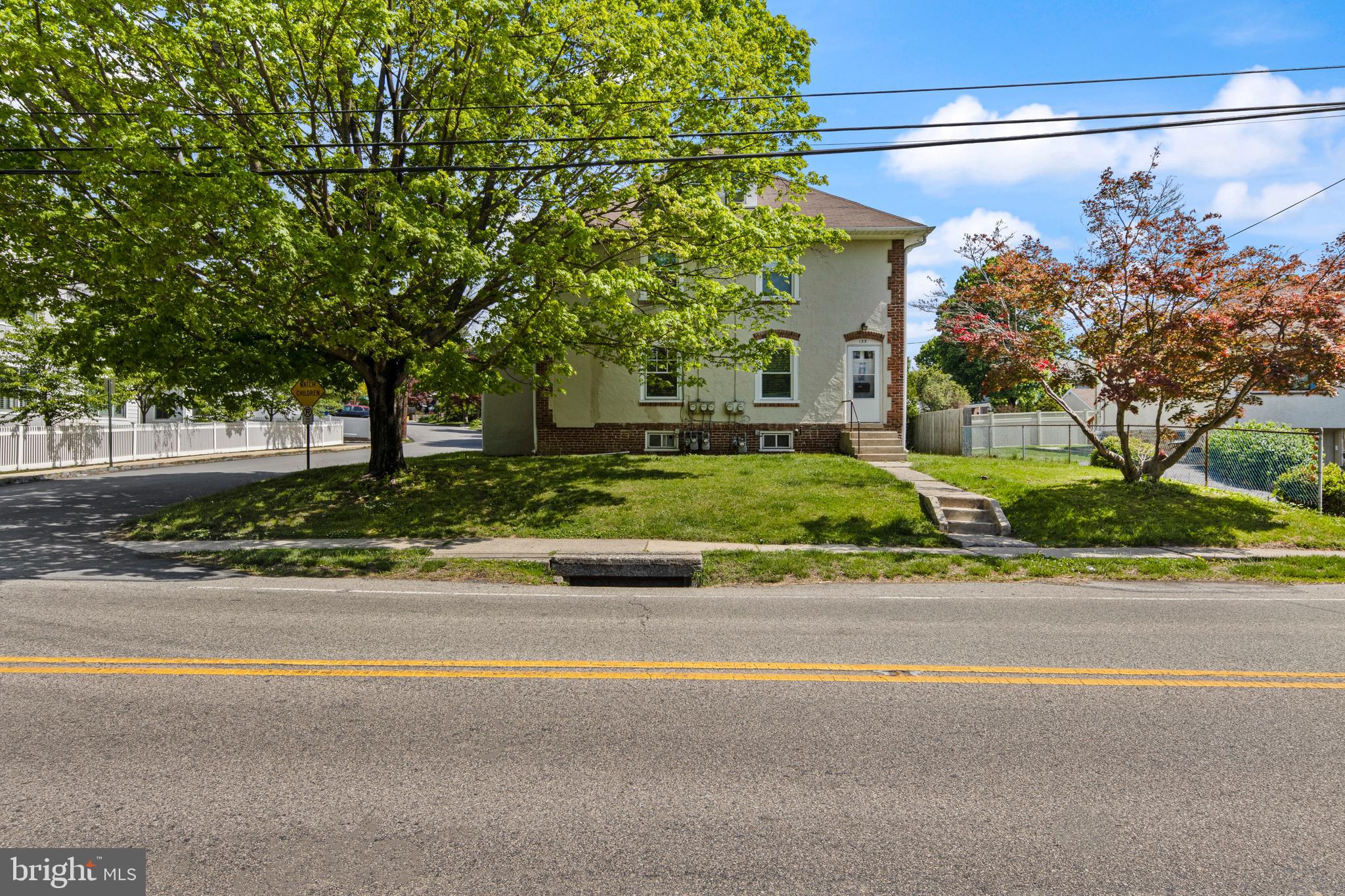 153 Conestoga Road Wayne, PA 19087 - Photo 12 of 13 a front view of a house with a yard and a garage