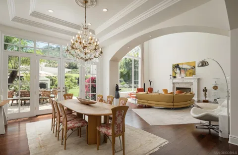 a living room with furniture a table and a chandelier