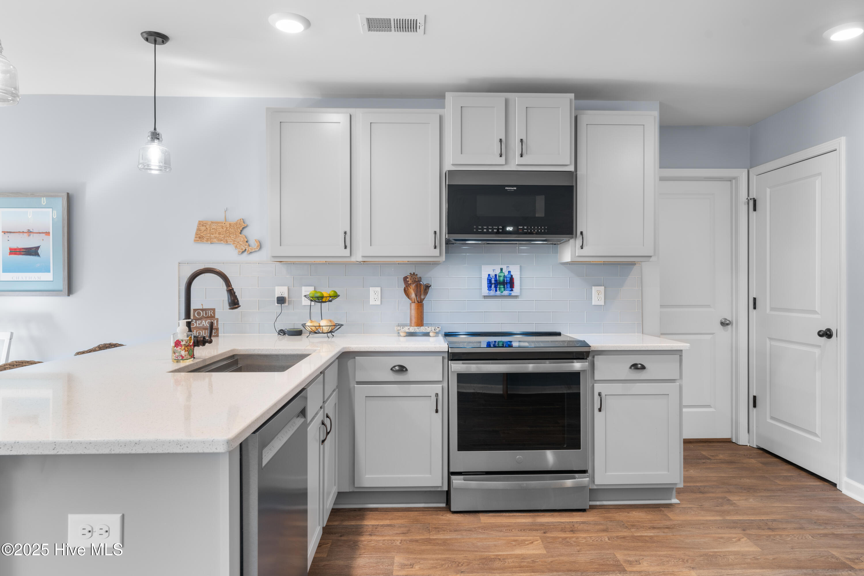 776 Buckeye Road Northeast Leland, NC 28451 - Photo 15 of 42 New Quartz Countertops and Glass Subway Tile backsplash in Kitchen