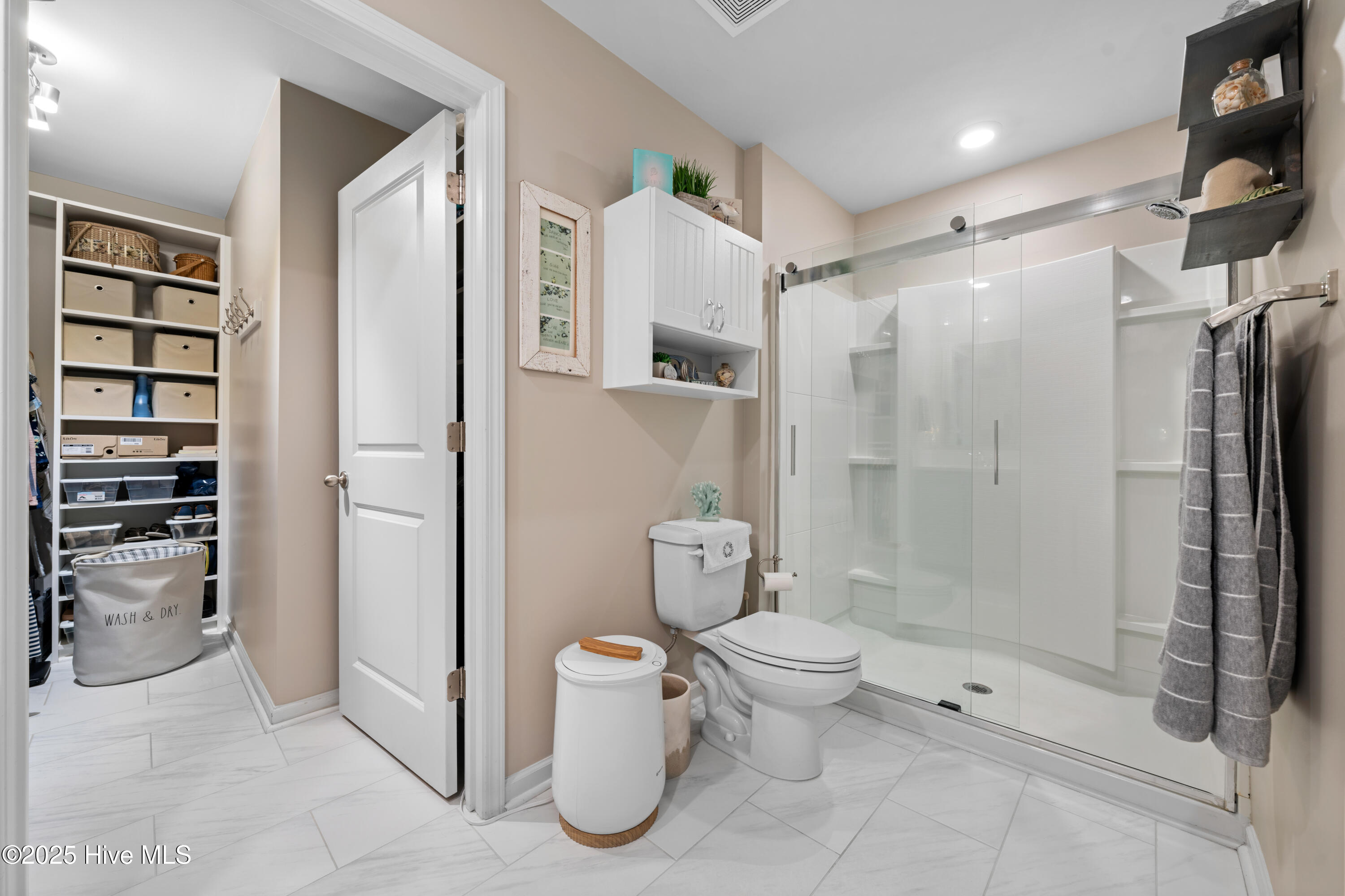 776 Buckeye Road Northeast Leland, NC 28451 - Photo 30 of 42 Owners Bathroom, Shower Door ungraded to a Kohler by-pass slider & Cabinetry above Commode