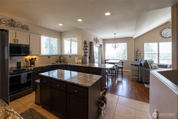 a kitchen with a stove sink and microwave
