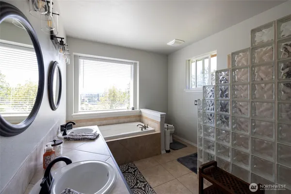 a bathroom with a sink a toilet and a mirror